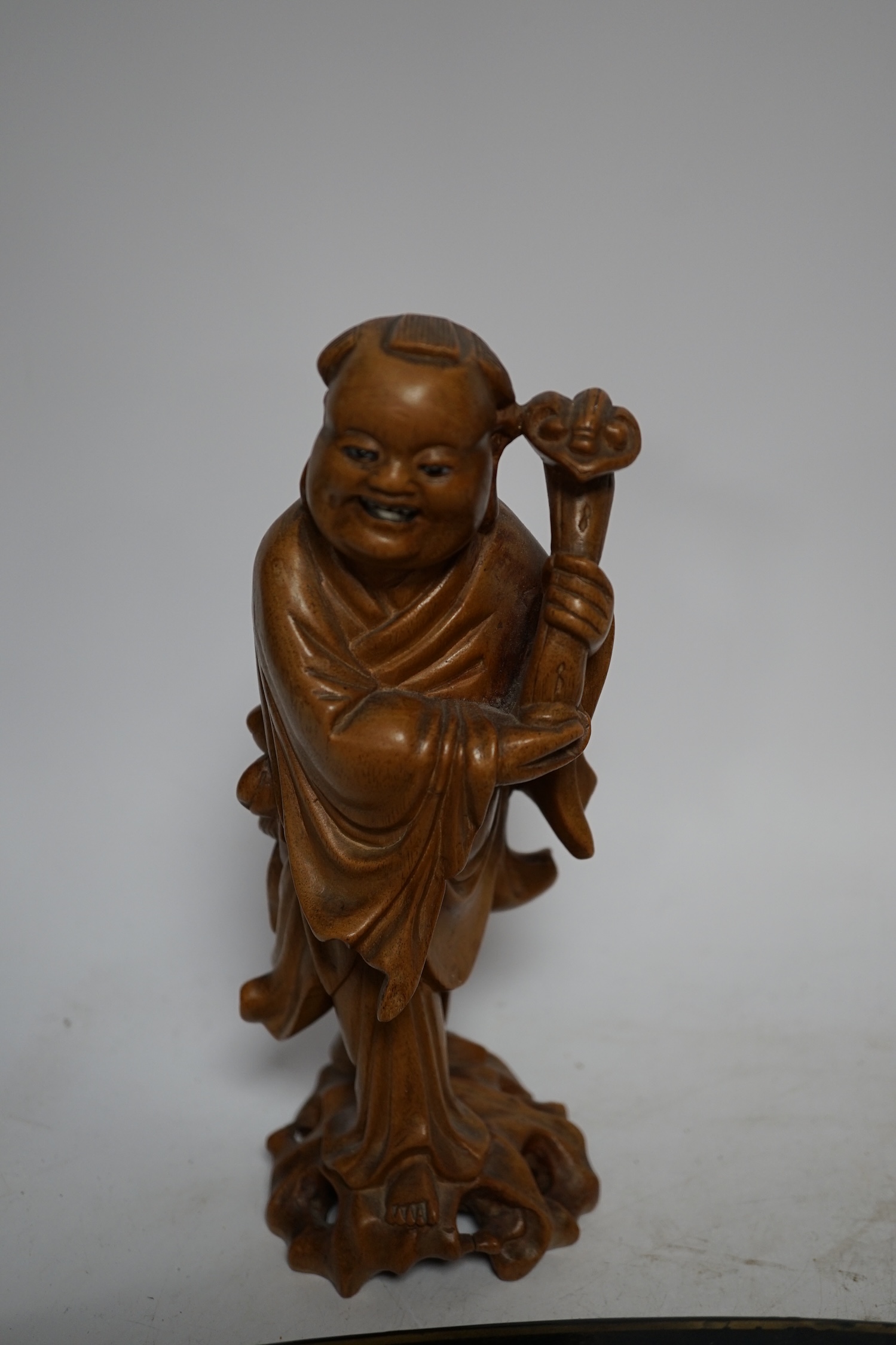 An oval japanned toleware tray and a pair of Chinese carved wood figures, largest 61cm wide